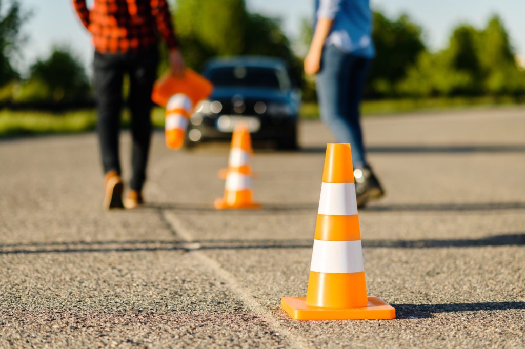 637264ac5ceaa52bc0fba761_instructor-and-student-on-road-with-traffic-cones-LUEDWNJ-1024x681